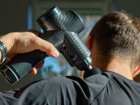 Man using massage gun