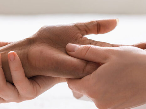 Massage therapist giving hand massage